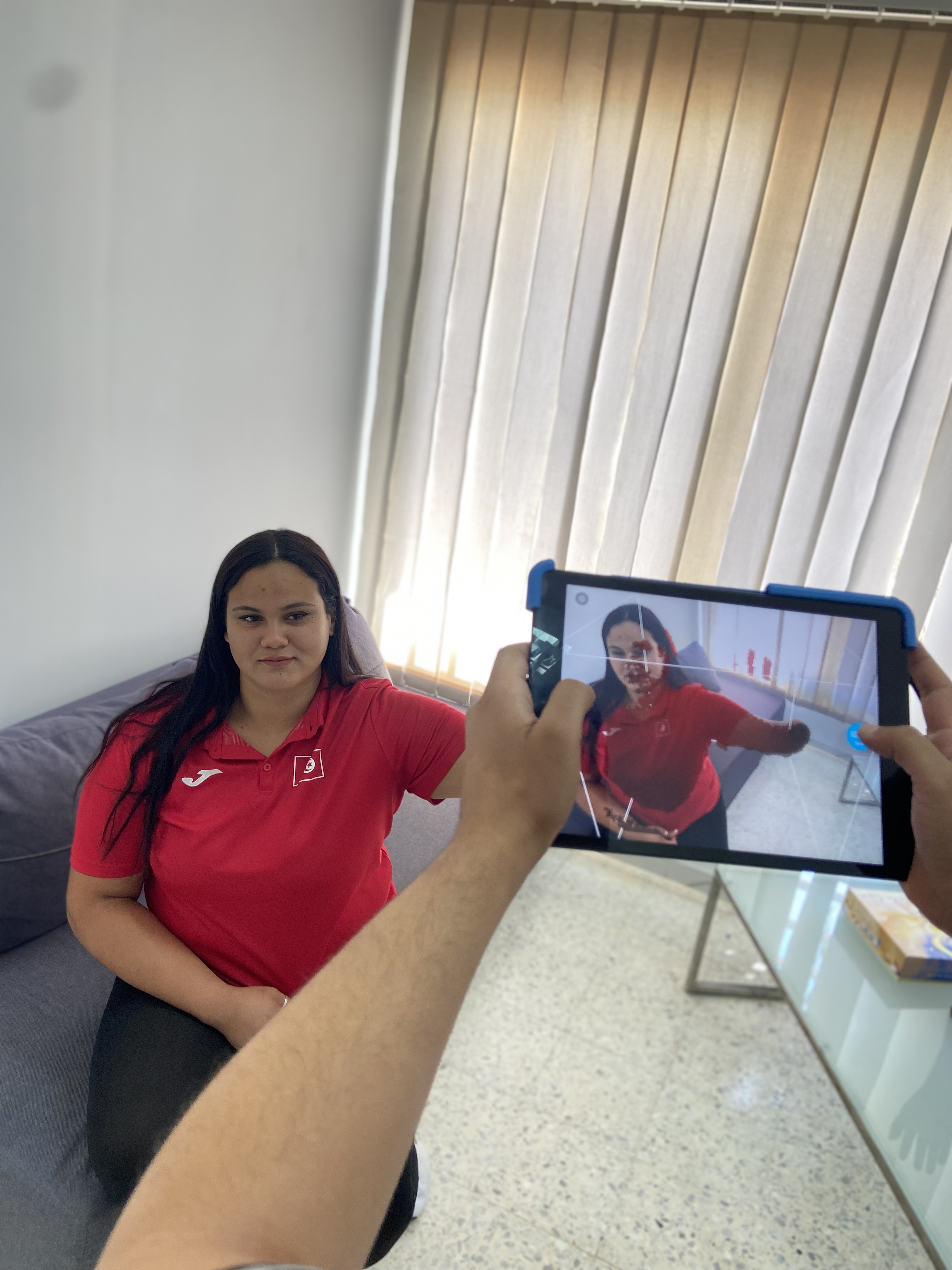 A clinician scans a patient using a tablet to capture a 3D model for an upper limb prosthetic fitting